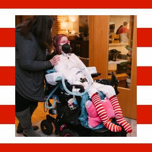 A girl in a wheelchair wearing striped socks